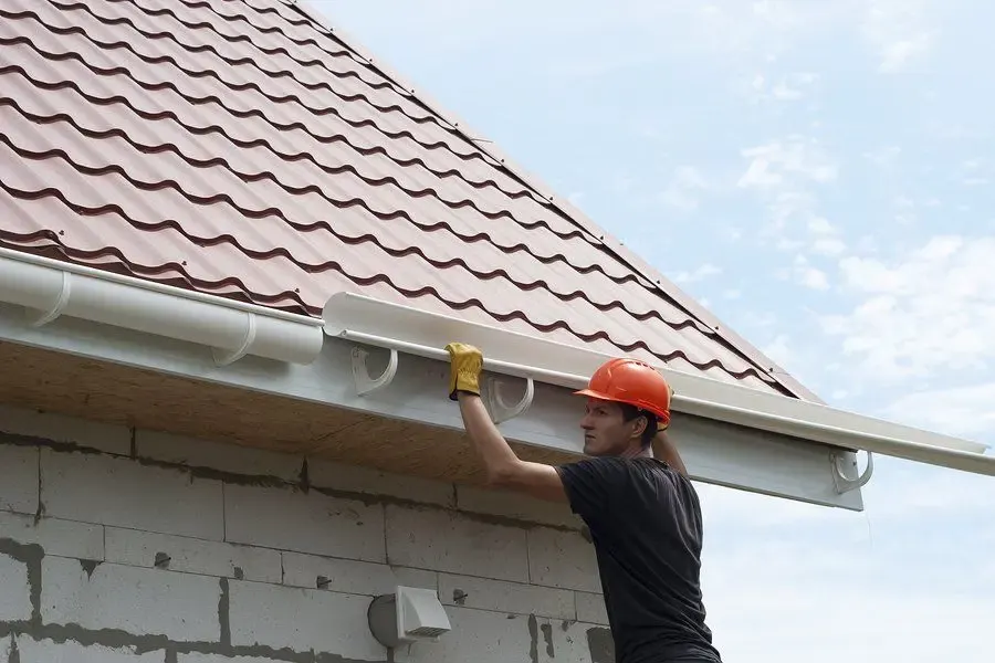 Fitting a new gutter section along a roofline